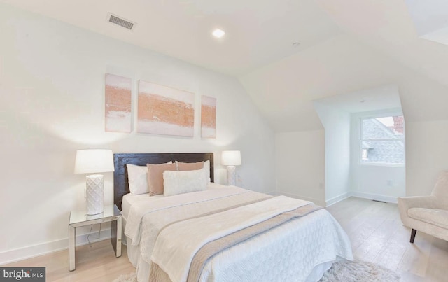 bedroom featuring light wood-type flooring and lofted ceiling