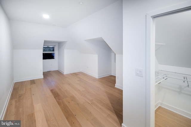 bonus room with light wood-type flooring