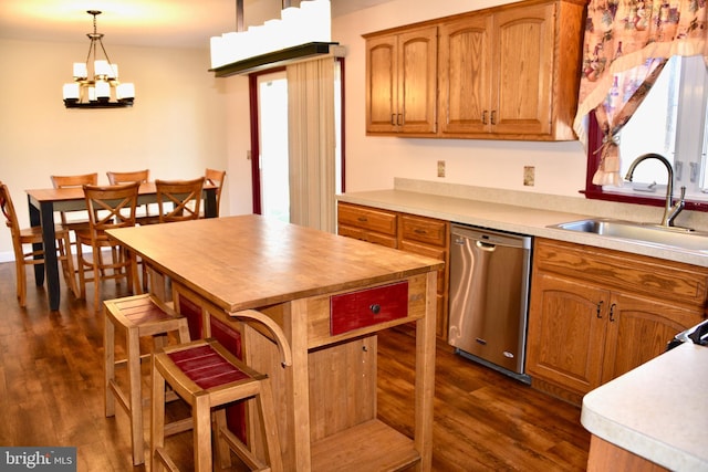 kitchen featuring a kitchen island, pendant lighting, sink, dark wood-type flooring, and stainless steel dishwasher