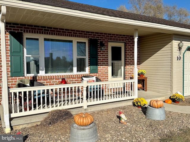 view of exterior entry with a porch