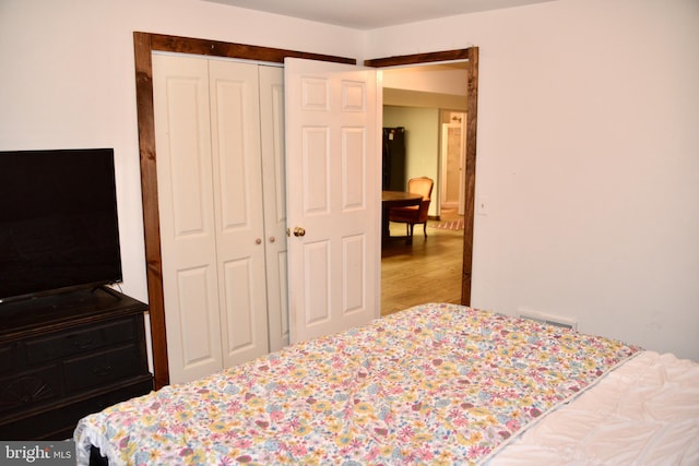 bedroom with hardwood / wood-style floors and a closet