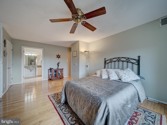 bedroom featuring ensuite bathroom, hardwood / wood-style floors, and ceiling fan