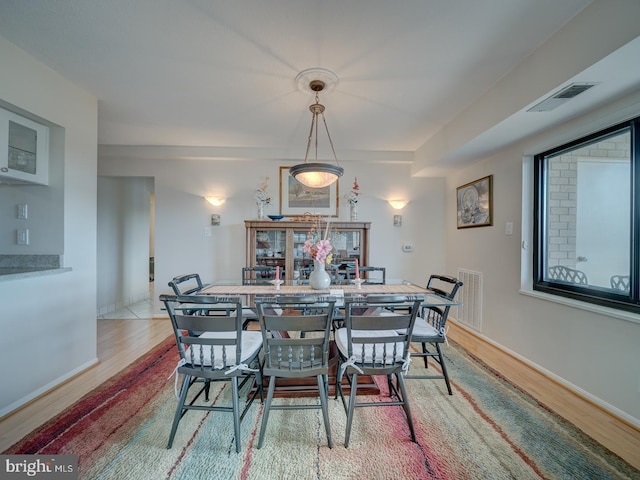 dining space with light hardwood / wood-style flooring