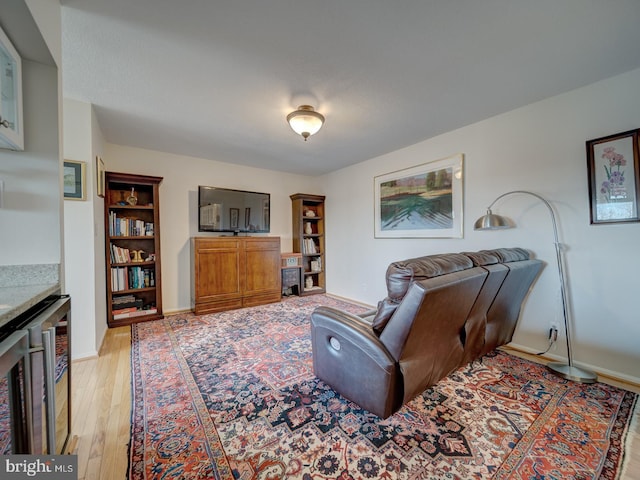 living room featuring light hardwood / wood-style flooring and beverage cooler