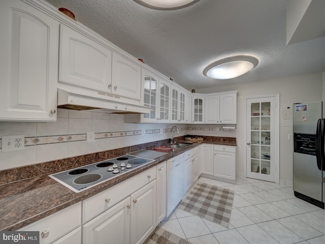 kitchen with white cabinetry, sink, dishwasher, and stainless steel refrigerator with ice dispenser