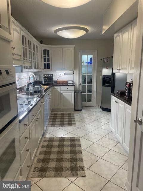 kitchen with white cabinetry and light tile patterned floors