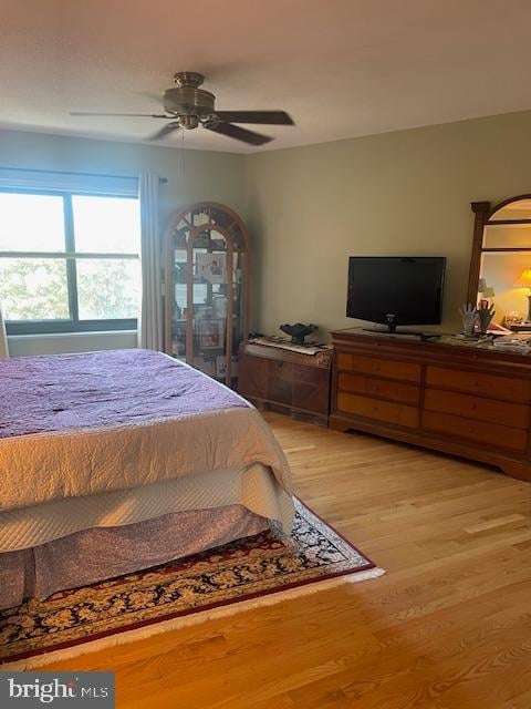 bedroom with ceiling fan and light hardwood / wood-style floors