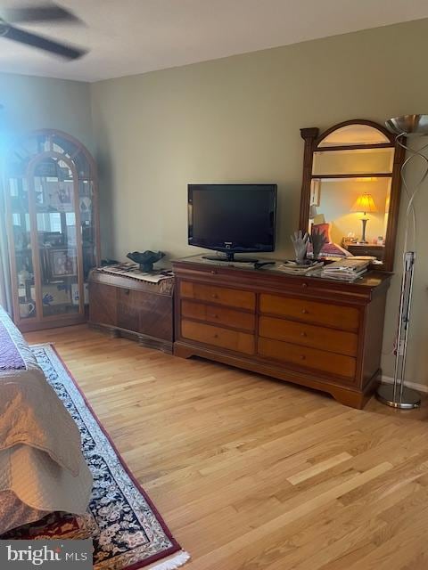 bedroom with light hardwood / wood-style floors and ceiling fan