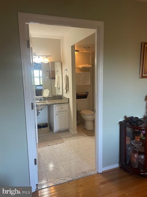 bathroom featuring toilet and wood-type flooring