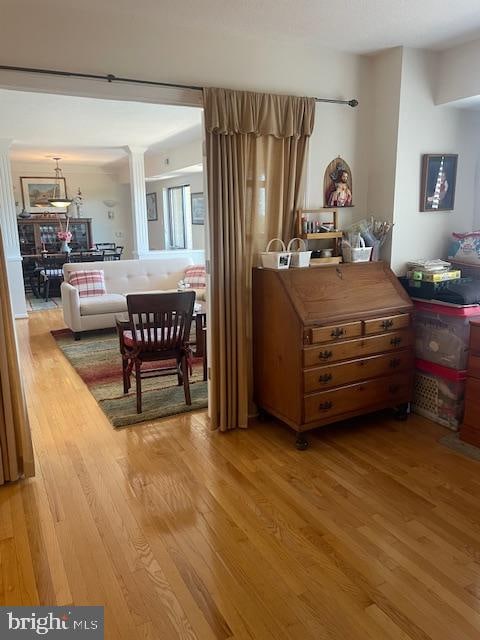 interior space featuring hardwood / wood-style flooring and ornate columns