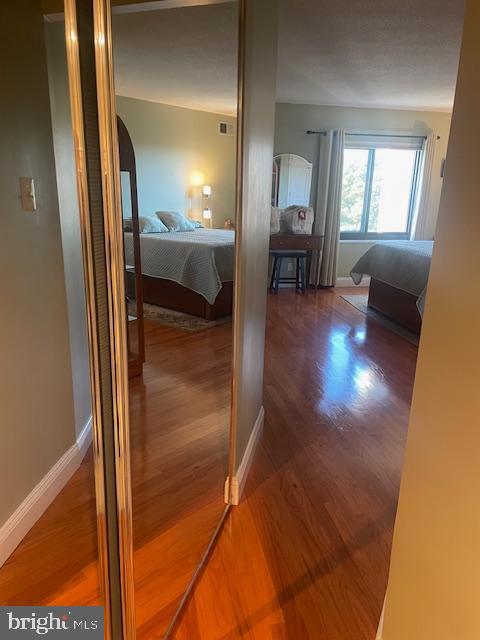 hallway with dark hardwood / wood-style floors