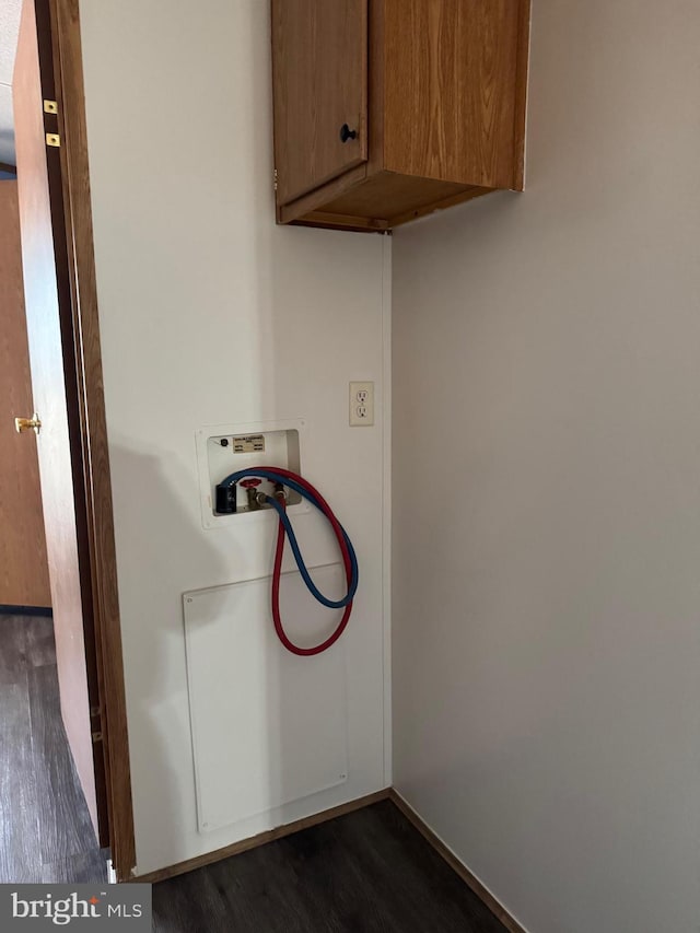 washroom featuring cabinets, washer hookup, and dark wood-type flooring