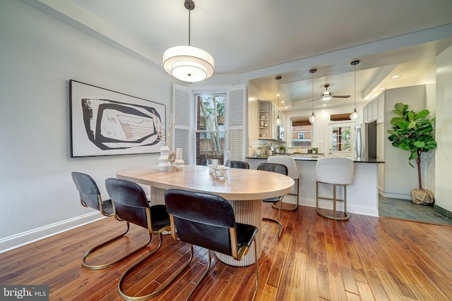 dining area with ceiling fan and light hardwood / wood-style flooring