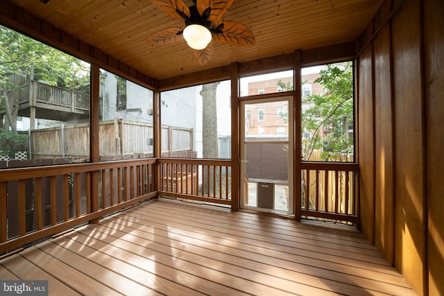 unfurnished sunroom featuring ceiling fan and wood ceiling