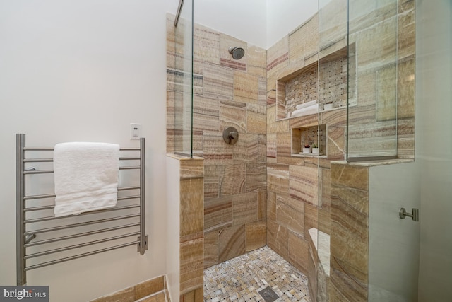 bathroom with radiator and tiled shower