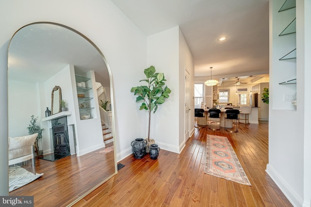 foyer with hardwood / wood-style floors and ceiling fan