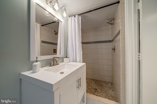 bathroom featuring curtained shower and vanity