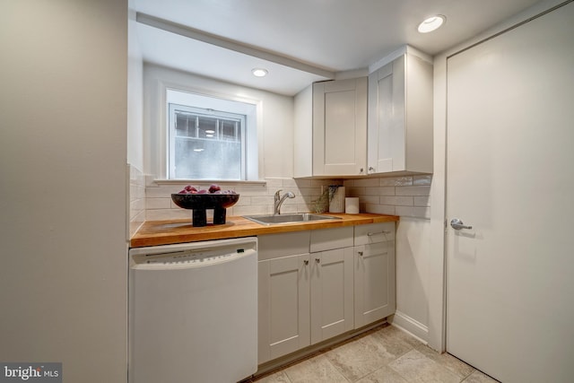 bar featuring butcher block counters, white cabinetry, sink, white dishwasher, and backsplash