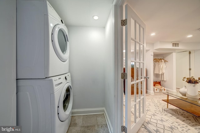 laundry room featuring stacked washing maching and dryer