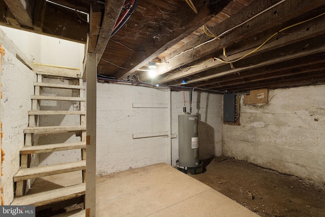 basement featuring electric panel and water heater