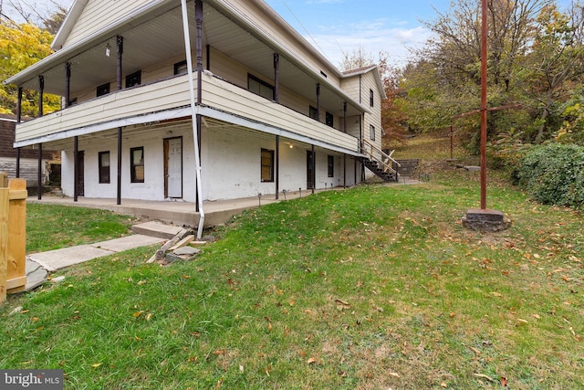 view of home's exterior featuring a lawn and a balcony