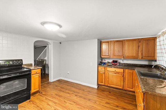 kitchen with black range with electric cooktop, sink, and light hardwood / wood-style floors