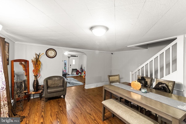 dining space featuring hardwood / wood-style flooring and ornamental molding