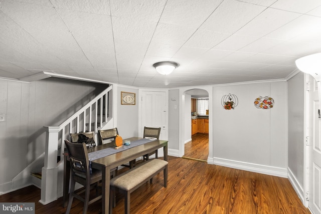 dining space featuring hardwood / wood-style flooring and crown molding