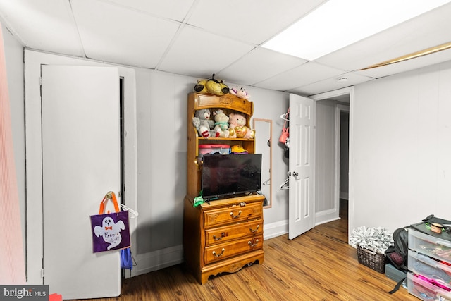 misc room featuring a drop ceiling and hardwood / wood-style floors