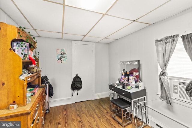 interior space with a paneled ceiling and dark wood-type flooring