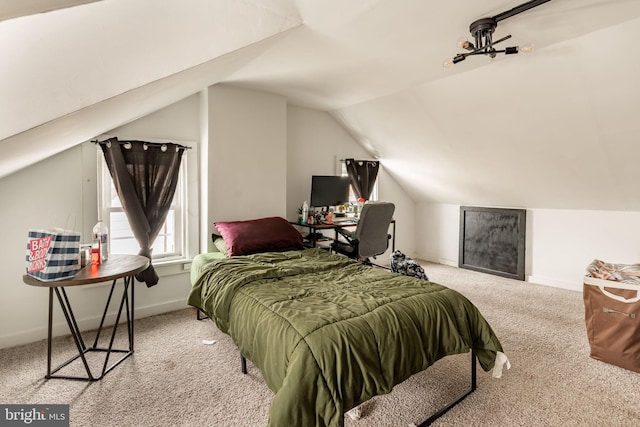 carpeted bedroom with lofted ceiling