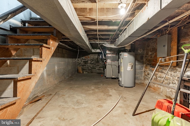 basement with electric panel, heating unit, and gas water heater