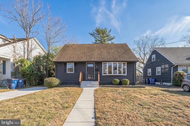 bungalow-style house featuring a front lawn