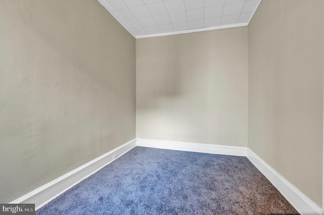 unfurnished room with carpet floors and crown molding