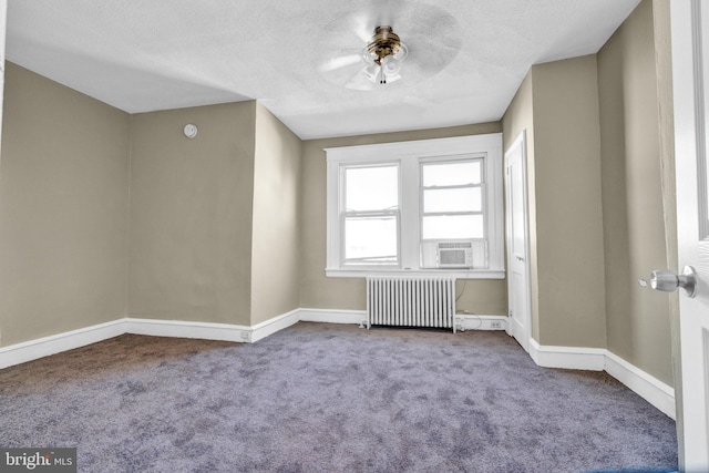 carpeted empty room with ceiling fan, a textured ceiling, radiator heating unit, and cooling unit