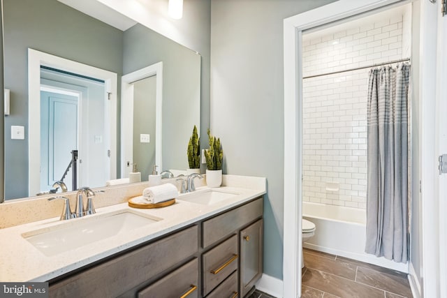 full bathroom with vanity, toilet, and shower / tub combo with curtain