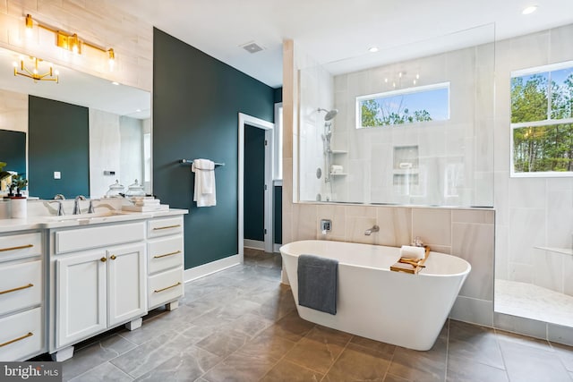 bathroom featuring vanity, plus walk in shower, and tile walls