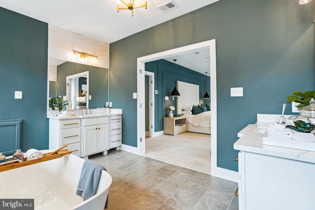 bathroom featuring vanity and a washtub