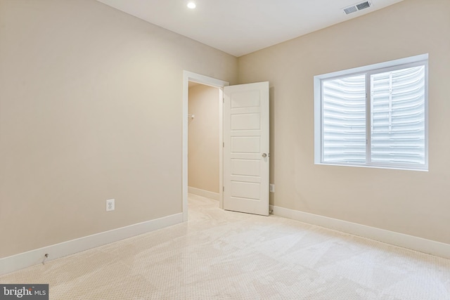 unfurnished room with light carpet