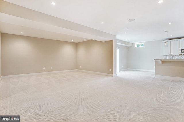 basement featuring light colored carpet