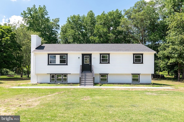 raised ranch featuring a front yard