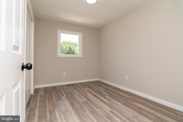 spare room featuring light hardwood / wood-style floors