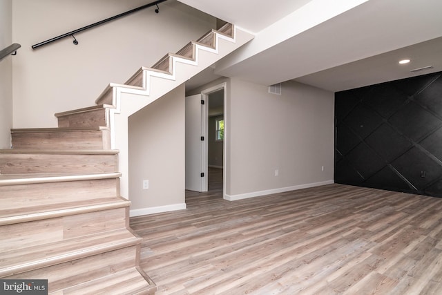 basement with wood-type flooring