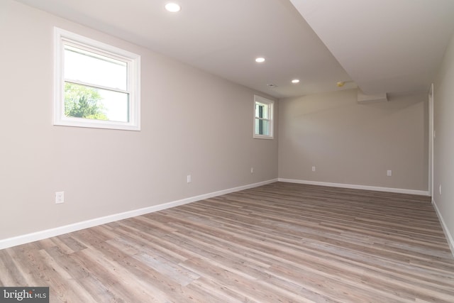 spare room featuring light hardwood / wood-style floors and plenty of natural light