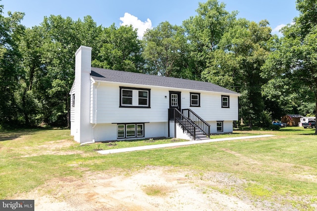 raised ranch with a front yard