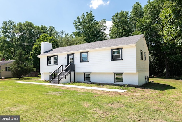 bi-level home with a front lawn