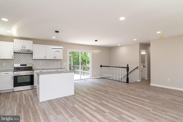 kitchen featuring hanging light fixtures, tasteful backsplash, stainless steel range, white cabinetry, and light hardwood / wood-style flooring