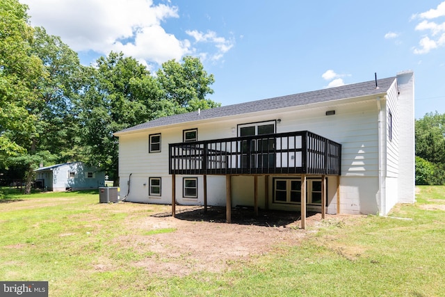 rear view of house with central AC, a yard, and a wooden deck