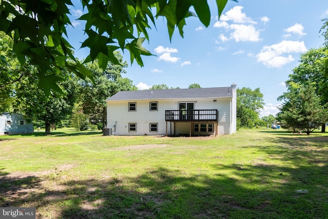 rear view of house with a wooden deck, central AC, and a yard