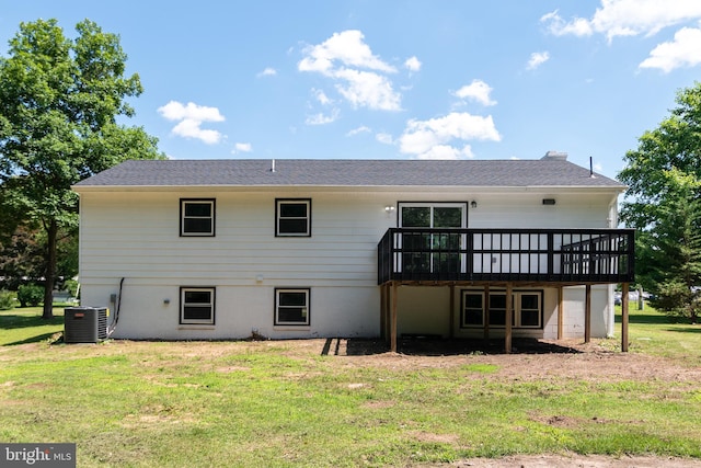 rear view of property with cooling unit, a yard, and a wooden deck